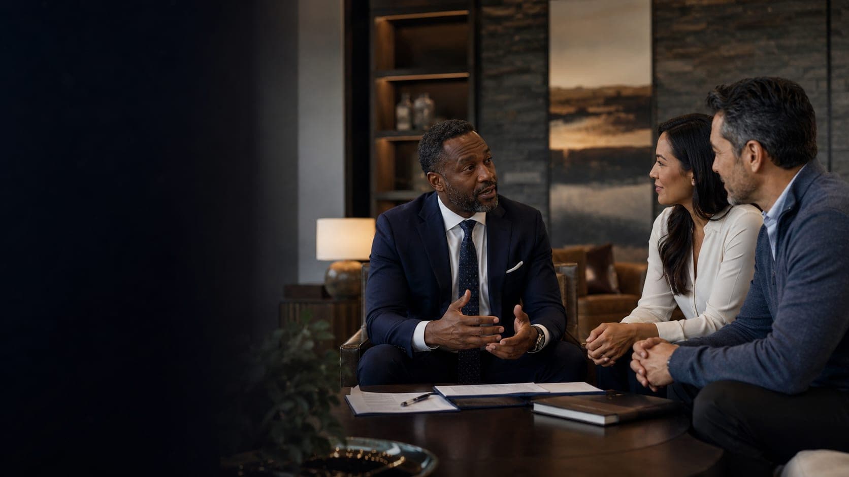 An advisor talking through options with a couple in a quiet study